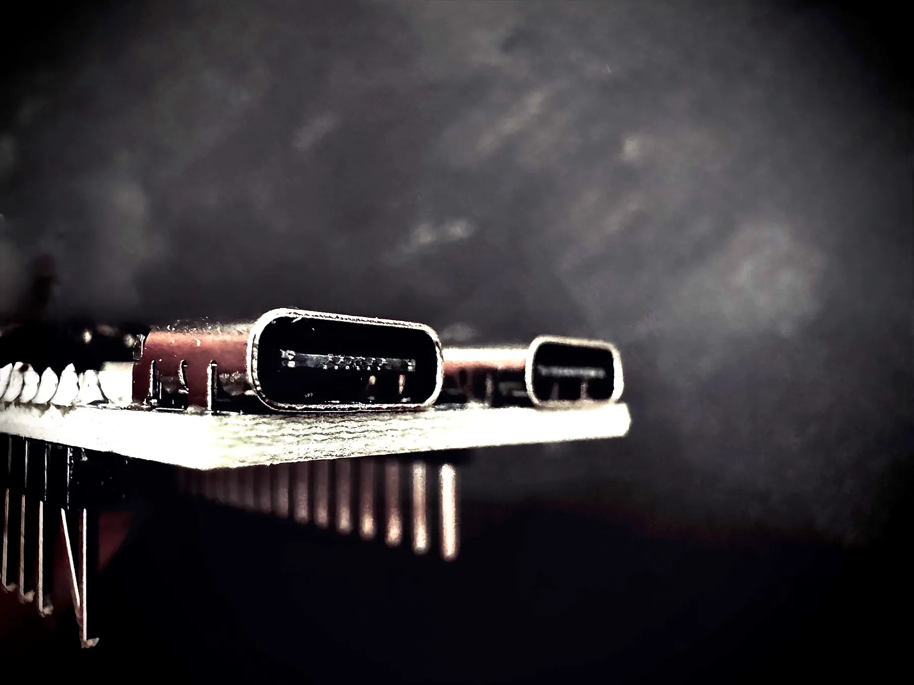 Close-up of a hand-soldered USB-C breakout board on a workbench